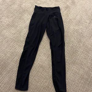 Black Adidas leggings with holes details on the bottoms legs